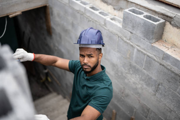 istock Portrait of a construction worker building a brick wall 1352748088