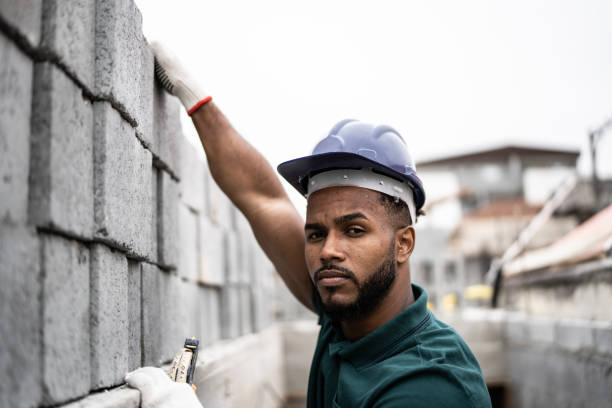 istock Portrait of a construction worker building a brick wall 1352748151
