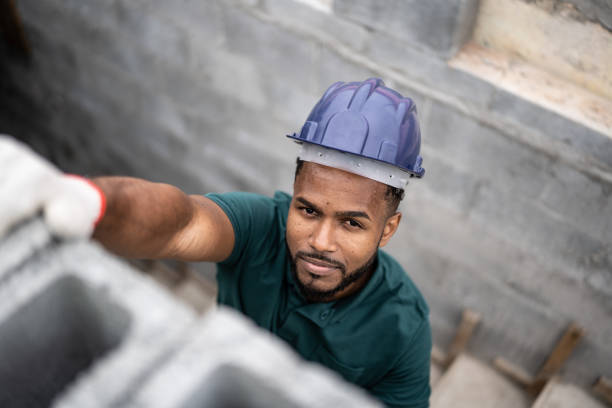 istock Portrait of a construction worker building a brick wall 1352748184
