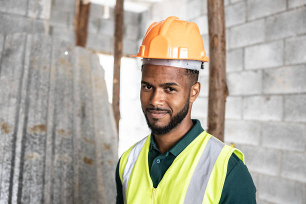 istock Portrait of a young construction worker at a construction site 1352748731