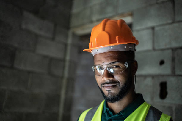 istock Portrait of a young construction worker at a construction site 1352748790