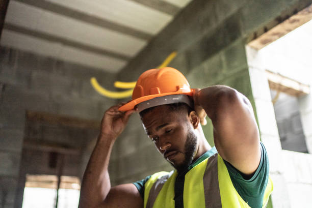istock Young construction worker dressing his uniform and protective workwear at a construction site 1352748840