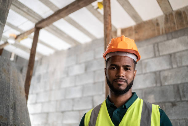 istock Portrait of a young construction worker at a construction site 1352748874