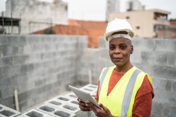 istock Portrait of a mature female engineer using digital tablet in a construction site 1352749031