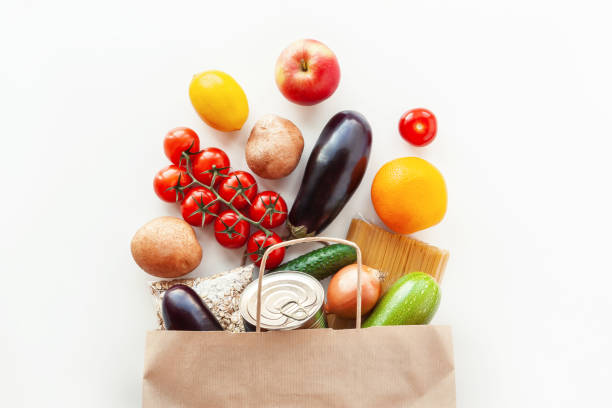 istock Food bag with grocery and vegetables on white 1352758422
