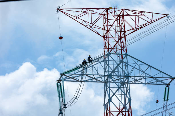 staff installation and modification of high voltage electrical cable system and cloud sky background Thailand
