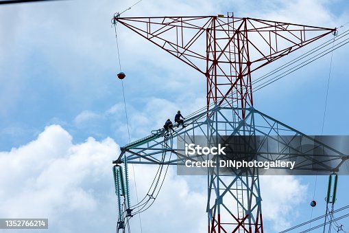 istock staff installation and modification of high voltage electrical cable system and cloud sky background Thailand 1352766214
