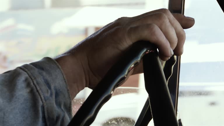 Male Hands On Steering Wheel in an Old Pickup Truck. Close-Up. 4K Resolution.