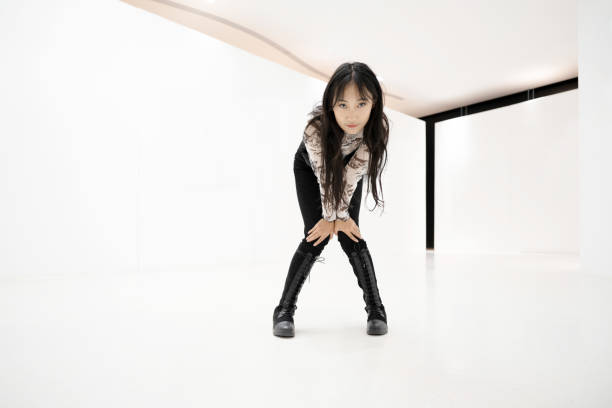 Women under white buildings in empty, clean, bright modern buildings
