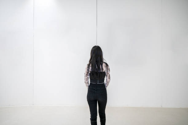 istock Women under white buildings in empty, clean, bright modern buildings 1352772780