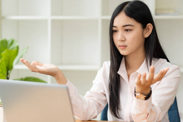 istock Young Asian students are smiling and looking at the camera in studying the future for themselves or personal learning ideas. Smiling young student studying online at home with books and laptop. 1352774765