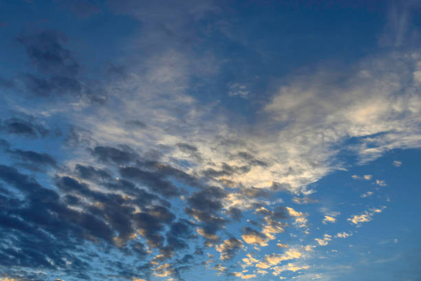 istock Puffy altocumulus clouds in a blue sunrise sky 1352777274
