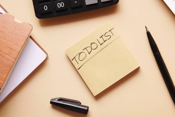 istock To do list in notebook with office suppliers on desk. 1352780374
