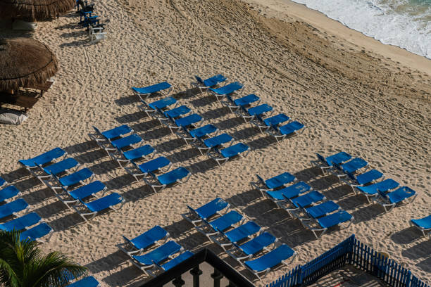Group of Tanning Chairs on the Beach at Sunrise in Cancun, Mexico