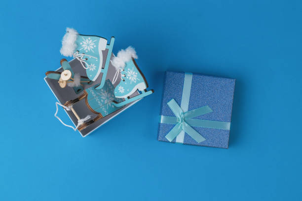 istock Top view of an open gift box with decorative winter accessories. 1352783381