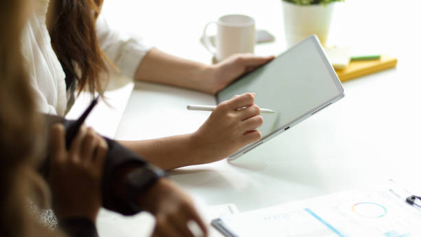 istock Cropped image of business employees working on a digital tablet 1352792815