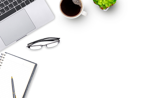 Mockup white office desk with laptop computer keyboard, blank diary notebook, pen, eye glasses, cup of coffee and cactus plant. Top view. Flat lay. Copy space,