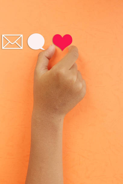istock Vertical close view hand is picking heart icon 1352794530