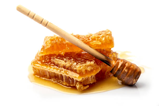 istock Honeycomb with honey, honey dipper. 1352795097