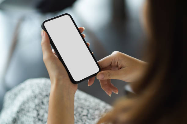 istock Female holding modern smartphone with white screen mockup 1352795871