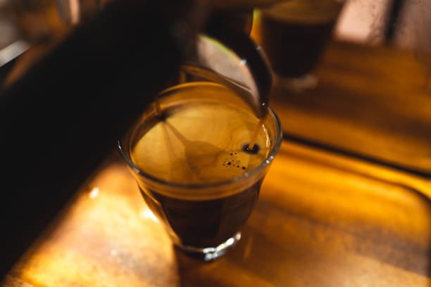 istock Coffee from the machine in a coffee mug 1352795886