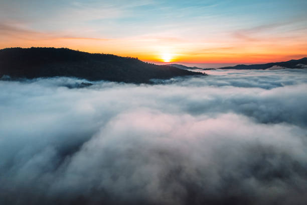 istock Flying above the clouds sunrise and fog 1352796474