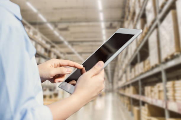 istock Staff using tablet with smart warehouse tracking inventory management and monitor control logistic system. 1352803581