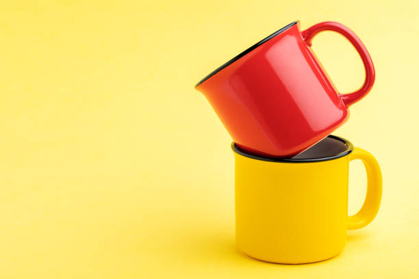 istock red and yellow Cup, on yellow background 1352804932