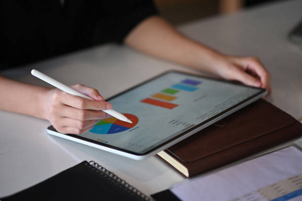 istock Close up view businesswoman analyzing financial graph on digital tablet. 1352809915
