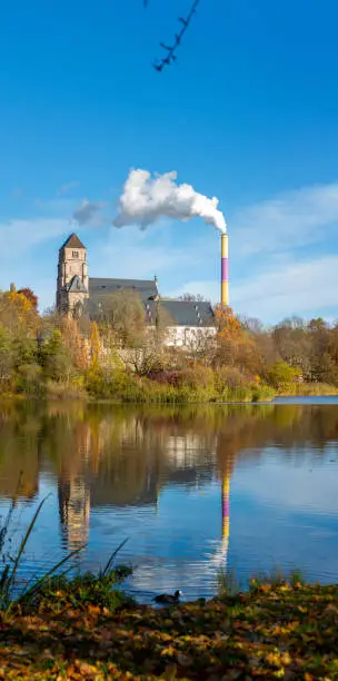 Landscape of public park in Chemnitz with its lake and castle and smoke stack as part of the scenery. Large composition of several photos.