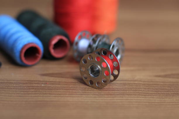 istock sewing threads of various colors on a wooden table 1352810654