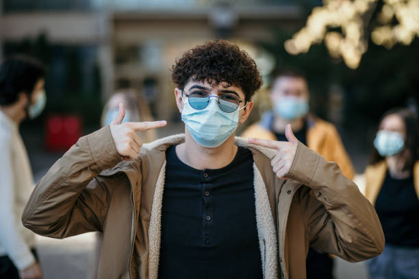 istock Happy male university student wearing protective face mask. 1352813078