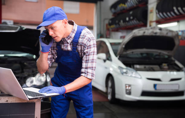 istock Confident auto mechanic talking on a smartphone in car service 1352815166