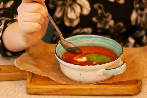 istock A woman is eating tomato soup 1352820575