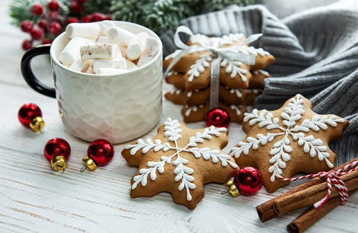 Christmas decorations,  cocoa and gingerbread cookies. White wooden background.