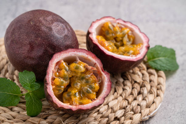 istock Delicious juicy passion fruit on gray table background. 1352822008