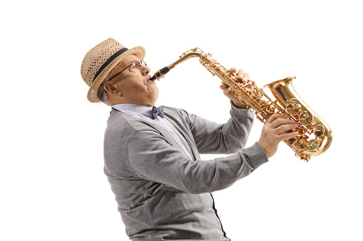 Elderly gentleman playing a saxophone isolated on white background