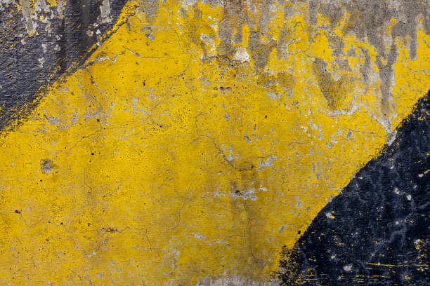 istock Image of a concrete wall painted yellow and black 1352822169