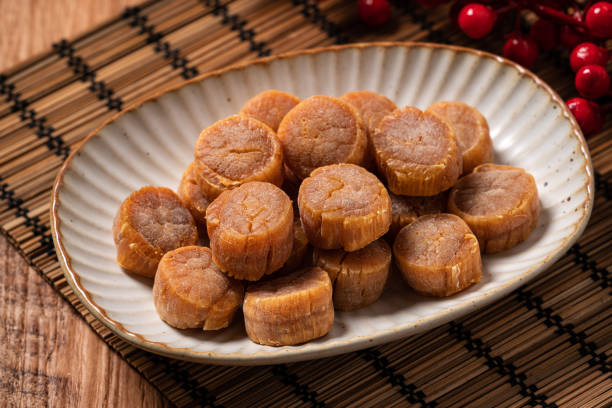istock Dried scallop on wooden table. 1352822317