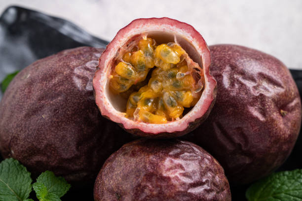 istock Delicious juicy passion fruit on gray table background. 1352823003