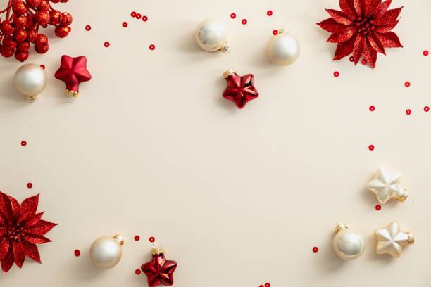 istock Red and beige Chrsitams decorations and confetti on beige background. Flat lay, top view, copy space. Merry Christmas and Happy New Year poster, greeting card, banner design. 1352823466