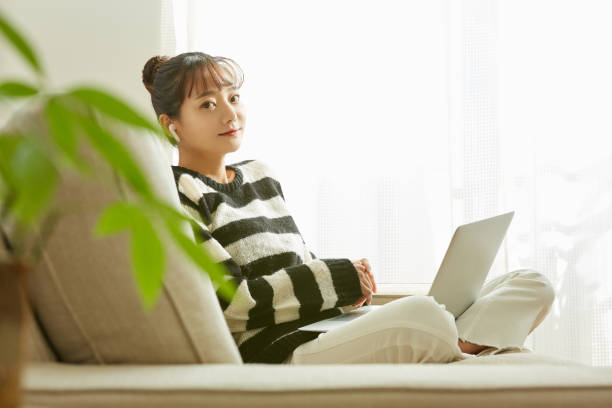 istock A young Asian woman working on her computer at home 1352823662