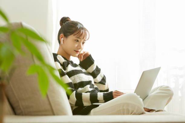 istock A young Asian woman working on her computer at home 1352823713