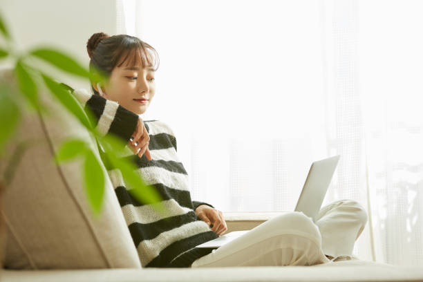 istock A young Asian woman working on her computer at home 1352823777