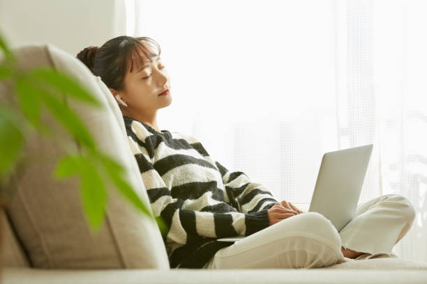 istock A young Asian woman working on her computer at home 1352823812
