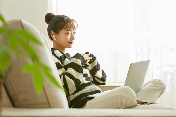 istock A young Asian woman working on her computer at home 1352823946