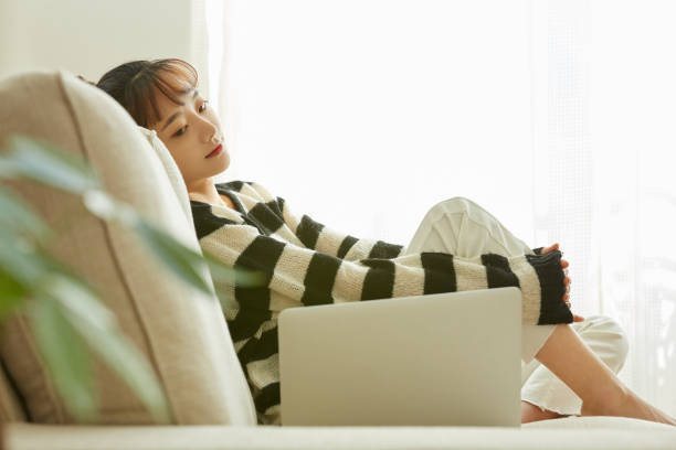 istock A young Asian woman working on her computer at home 1352824410
