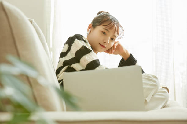 istock A young Asian woman working on her computer at home 1352824411