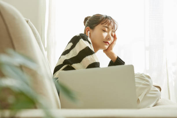 istock A young Asian woman working on her computer at home 1352824419
