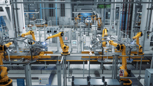 istock Car Factory 3D Concept: Automated Robot Arm Assembly Line Manufacturing Advanced High-Tech Green Energy Electric Vehicles. Construction, Building, Welding Industrial Production Conveyor. 1352825095